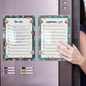 Detailed view of hand writing on Christmas acrylic magnetic weekly fridge planner and markers