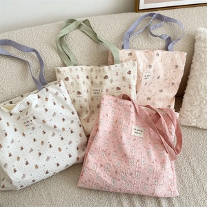 Detail showing seersucker fabric texture and cute animal prints on various tote bags
