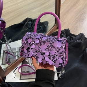 Detailed close-up of purple sequin crossbody bag with silver chain strap and top handle