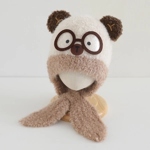 Detail of plush bear-shaped toddler hat with ear flaps and soft fleece texture