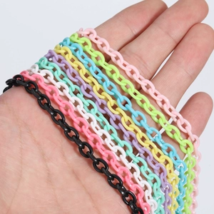 Hand holding colorful 6x8mm acrylic link chains for DIY jewelry making on white background