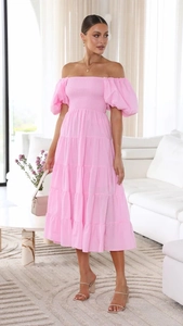 Detail of pink off-shoulder dress with smocked bodice and layered ruffle skirt