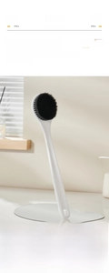 Detail of the long-handled bath brush showing soft bamboo charcoal bristles for back scrubbing