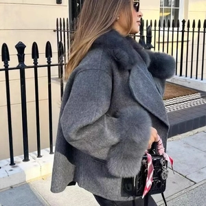 Elegant grey wool blend coat featuring plush fur collar and cuffs in loose silhouette