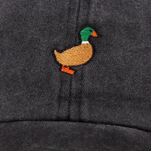 Macro detail of high-quality mallard duck embroidery on a dark cotton baseball cap