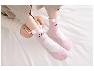 Close-up of pink coral fleece socks featuring cute cat embroidery and 3D plush ears