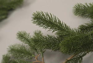 Macro shot of realistic green PE pine needle branches for Christmas home decor