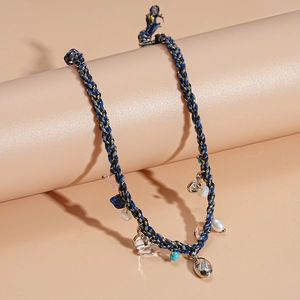 Detail of bohemian handmade woven necklace with colorful stones and pearls on display
