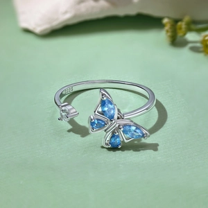 Macro shot of S925 silver ring featuring blue teardrop zircon and butterfly design