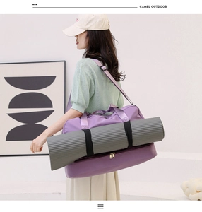 Detail view of purple waterproof fitness bag with external straps for yoga mat storage