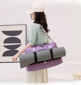 Detail view of purple waterproof fitness bag with external straps for yoga mat storage