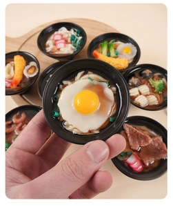 Miniature 7cm udon noodle bowl held in hand showing realistic details and textures