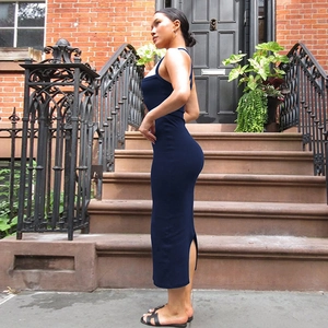 Detailed side view of navy blue halter dress with back crisscross and side slit