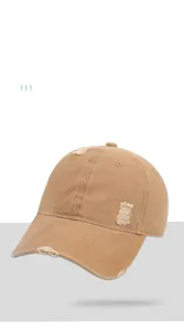 Detailed close-up of distressed brim on khaki washed cotton vintage baseball cap