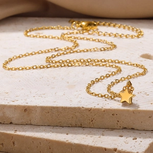 Polished gold star pendant on O-chain with adjustable lobster clasp on stone base