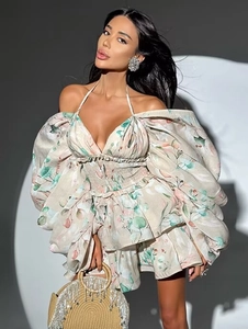 Detailed close-up of floral print mini dress with tiered ruffles and puff sleeves