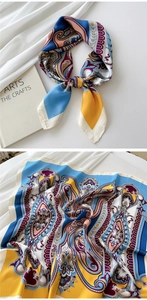 Macro detail of silky paisley square scarf featuring vibrant patterns and satin finish