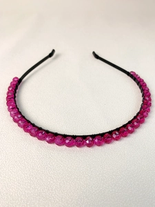 Detail of handmade fuchsia beaded headband with faceted gems on a slim black metal frame