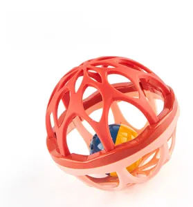 Macro shot of bicolored hollow-out baby rattle ball for fine motor skills training