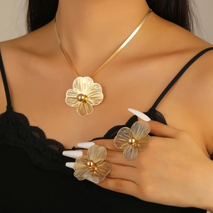 Detail of gold flower jewelry set with hollow petal texture on a fashion model