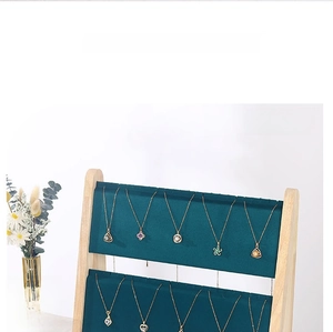 Detail of double-layer dark green velvet jewelry stand with natural bamboo wood frame