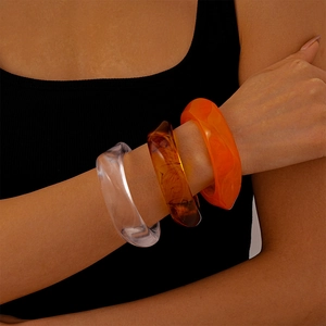 Three-piece set of chunky irregular acrylic resin bangles in amber and orange colors