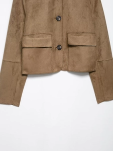 Detail view of brown faux suede jacket featuring functional double pockets and button closures