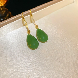 Detail shot of elegant green teardrop glass earrings with gold-plated sterling silver hooks