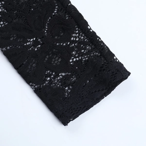 Close-up of black floral lace fabric with intricate hollow embroidery and sleeve detail