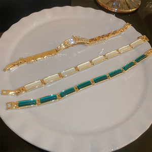 Detailed close-up of gold plated bracelets with cat eye stones and sparkling zircons