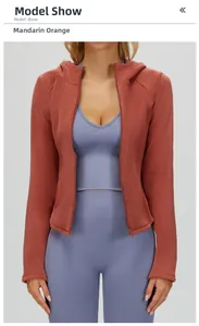 Close-up of honey orange fleece jacket with hood and zip-up detail on model