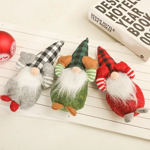 Detailed view of three festive Christmas gnomes in plaid hats with soft white beards