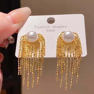 Detail showing S925 silver needles on gold flower tassel earrings with white pearls