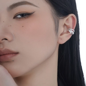Irregular textured S925 sterling silver ear cuff with black stone on a female model