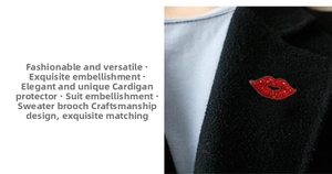 Detail shot of a sparkling red crystal lip brooch pinned on a black suit lapel