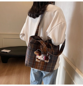 Detail of wool plaid tote bag featuring a cute dachshund puppy embroidery on the front