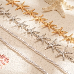 Two-piece gold and silver starfish bead necklace set with elegant white pearls for beach vacation