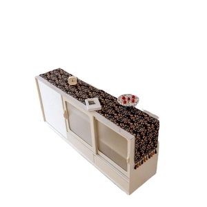 Floral table runner with fringe tassels on a minimalist cabinet for home decor