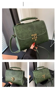 Detail view of dark green vintage embossed leather bag with floral relief pattern