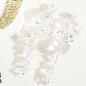 Macro detail of long glacier-style tassel earrings with transparent faceted glass beads