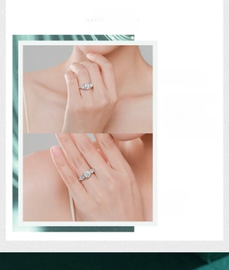 Detailed view of s925 silver three-stone ring with round and pear-cut simulated diamonds