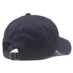 Detail of adjustable metal buckle and cotton fabric on a navy blue baseball cap