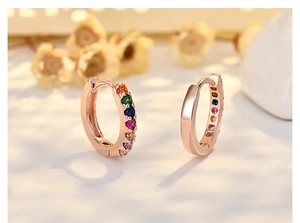 Detailed close-up of rose gold hoop earring encrusted with colorful cubic zirconia