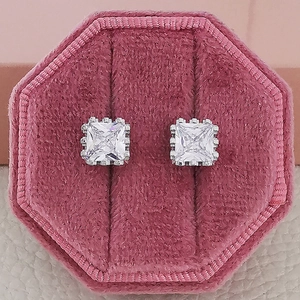 Sparkling silver square zircon stud earrings with crown details in a pink velvet box
