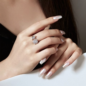Detailed view of an adjustable silver ring featuring square and triangle cut cubic zirconia