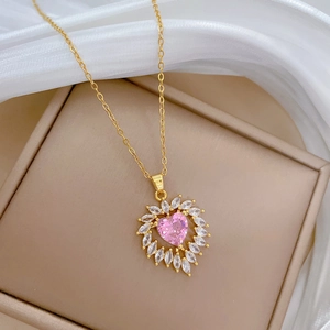 Pink heart crystal necklace in gold titanium steel on silk fabric display