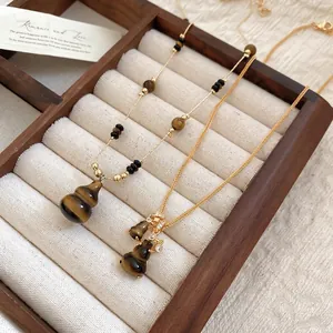 Tiger eye stone gourd pendant necklace with gold chain and beaded accents in jewelry box