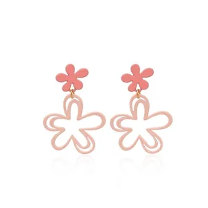 Detail view of pink double-layer floral earrings with matte finish and 5-petal design