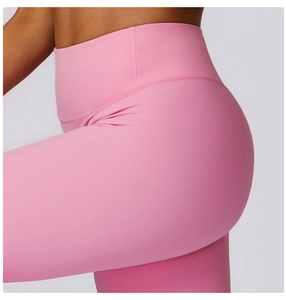 Close-up of pink high-waisted yoga pants showing the lifting effect and peach hip curve