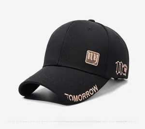 Detail of black baseball cap featuring gold TOMORROW embroidery on brim and side gothic NY